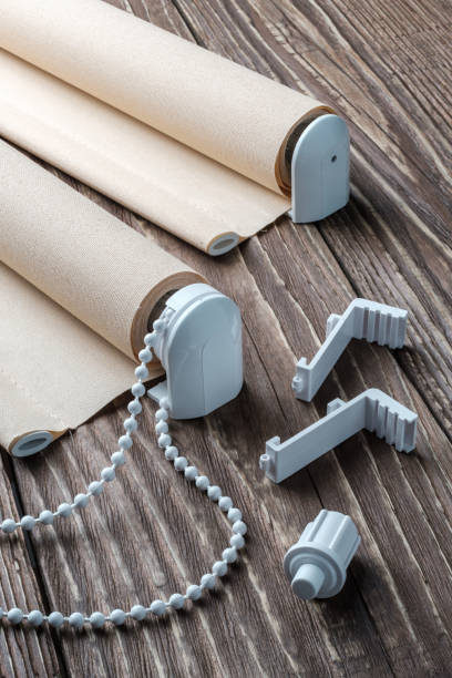istock The beige rolled blind is on a wooden surface. 924727756