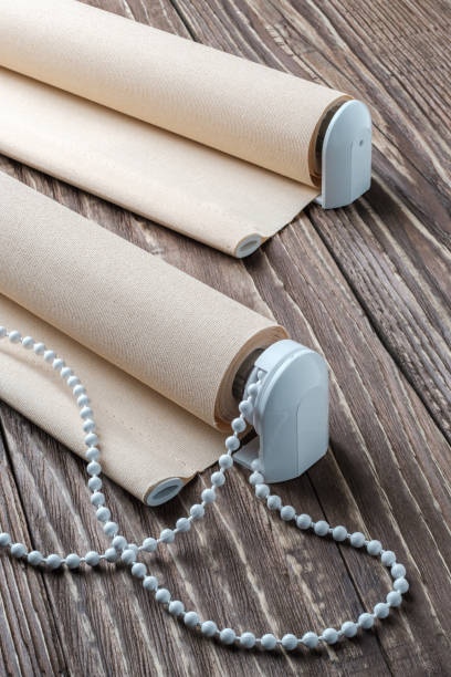 istock The beige rolled blind is on a wooden surface. 924727810