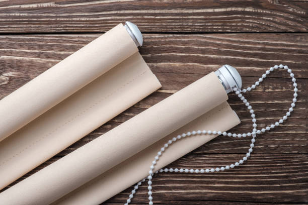 istock The beige rolled blind is on a wooden surface. 924727908