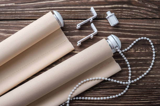 istock The beige rolled blind is on a wooden surface. 924727964