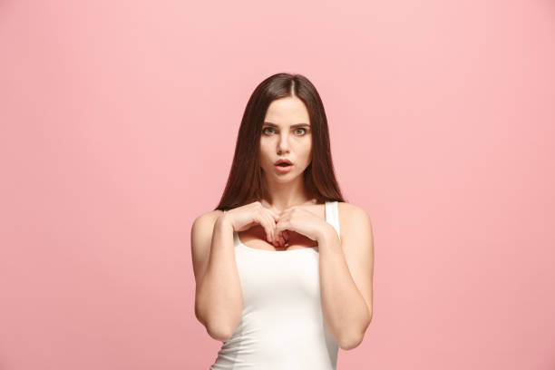 istock Let me think. Doubtful pensive woman with thoughtful expression making choice against pink background 924728504