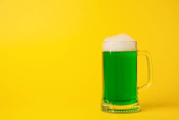 istock St Patrick's Day concept green beer on yellow background 924732122