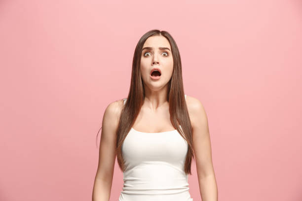 Portrait of the scared woman on pink I'm afraid. Fright. Portrait of the scared woman. Business woman standing isolated on trendy pink studio background. Female half-length portrait. Human emotions, facial expression concept. Front view women screaming surprise fear stock pictures, royalty-free photos & images