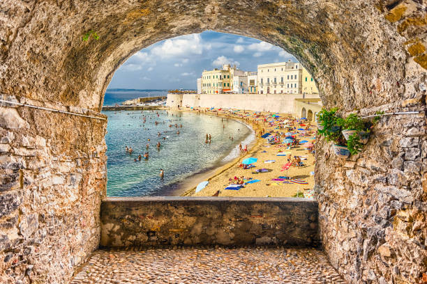 Rock balcony overlooking Gallipoli waterfront, Salento, Apulia, Italy Scenic rock arch balcony overlooking Gallipoli waterfront, Salento, Apulia, Italy lecce stock pictures, royalty-free photos & images