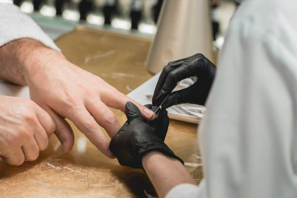 istock mans manicure master during nail treatment 924737970