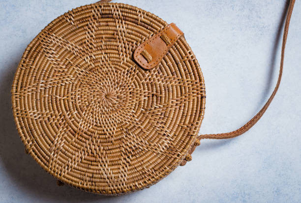 istock Fashionable rattan bag on light background. Copy space, top view 924741548