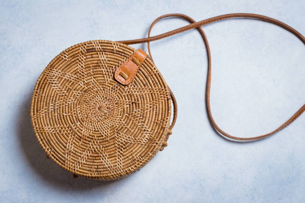 istock Fashionable rattan bag on light background. Copy space, top view 924741550