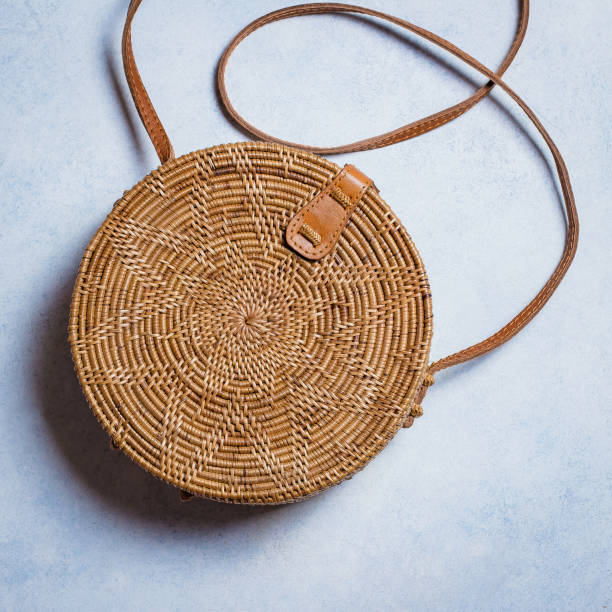 istock Fashionable rattan bag on light background. Copy space, top view 924741574