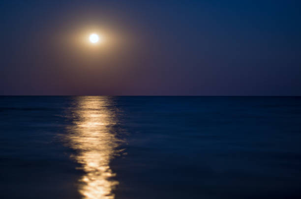 istock moon in the night blue sky, sea horizon, waves, reflection of light 924744938