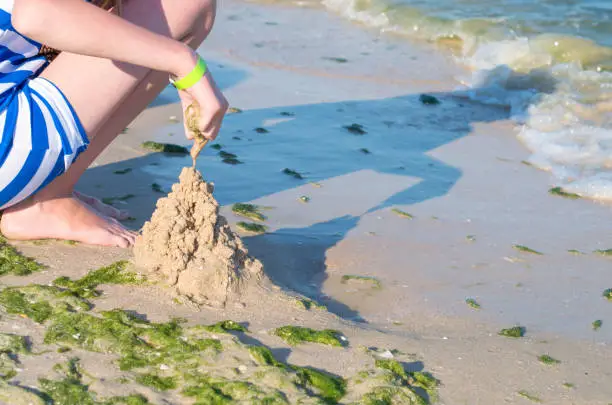 Photo of girl making a sand castle