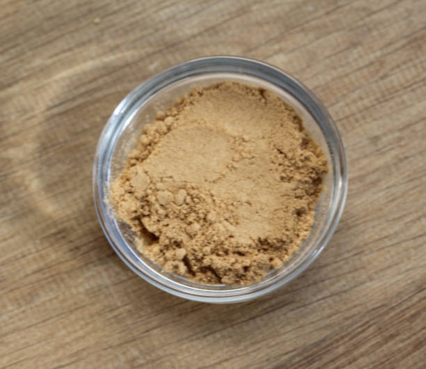 istock Glass bowl with ginger powder on wooden background 924745506