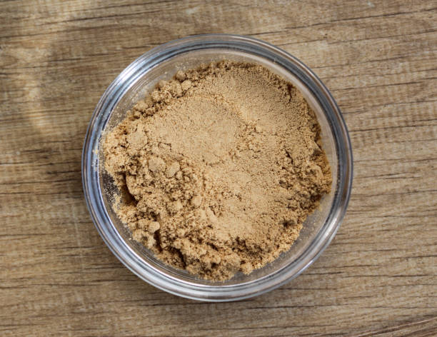 istock Glass bowl with ginger powder on wooden background 924745532