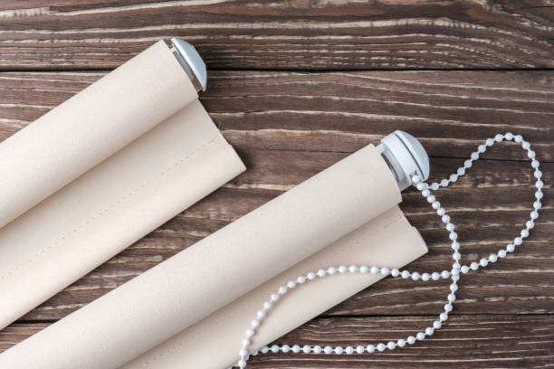 istock The beige rolled blind is on a wooden surface. 924748594