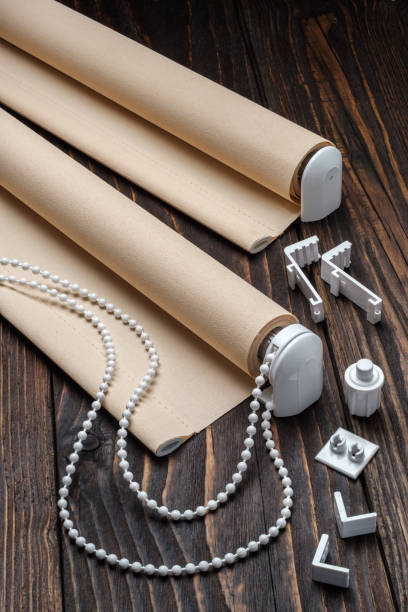 istock The beige rolled blind is on a wooden surface. 924749100