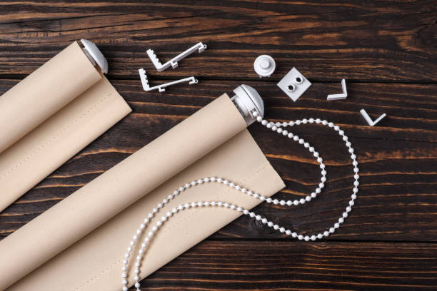 istock The beige rolled blind is on a wooden surface. 924749174