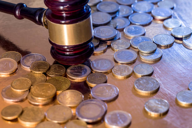 istock euro coin and hammer isolated on gold 924749182