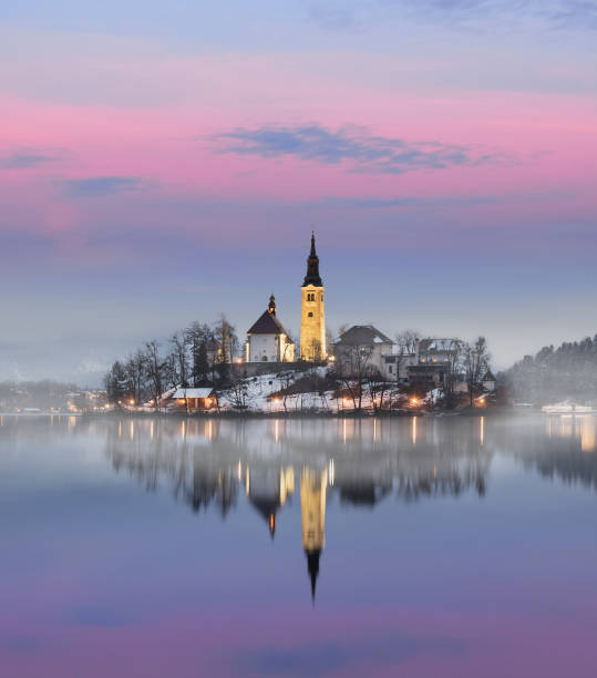 traumhaften sonnenuntergang an der see bled im winter, slowenien - castle slovenia winter snow stock-fotos und bilder