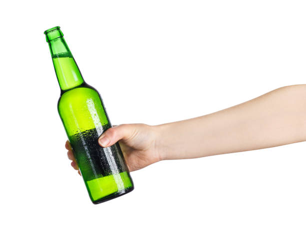 istock female hand with green beer bottle 924760738