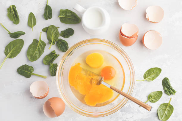 istock Raw ingredients for omelette with milk and spinach. Breakfast concept, top view, copy space. 924761198