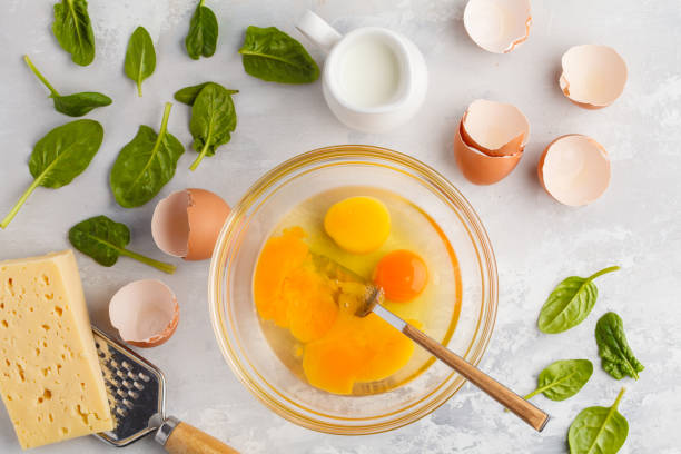 istock Raw ingredients for omelette with cheese and spinach. Breakfast concept, top view, copy space. 924761280