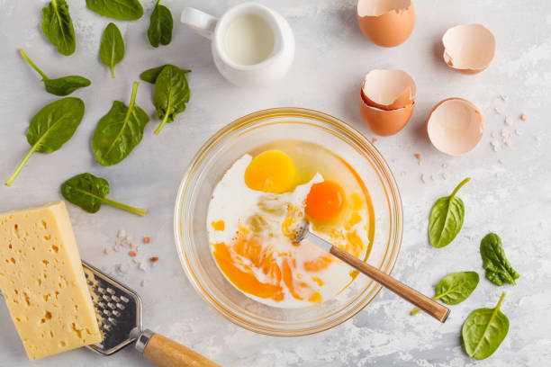 istock Raw ingredients for omelette with cheese and spinach. Breakfast concept, top view, copy space. 924761712