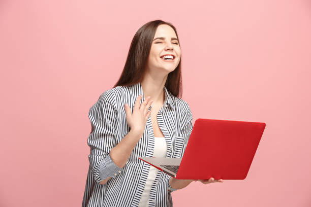 istock Businesswoman with laptop on pink studio 924766792