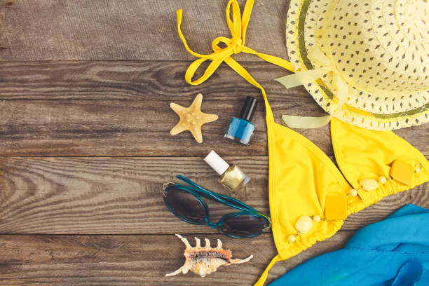 istock Summer accessories on wooden old background. Top view. Toned image. 924772802