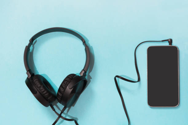 istock Modern style black headphones and smartphone on blue background. 924786194