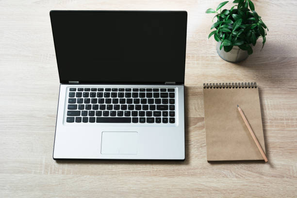 istock Open laptop on office wooden desk table. Top view, copy space. 924786198