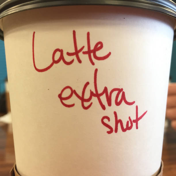 istock Coffee Moments: “latte extra shot” written on take-away coffee cup 924787136