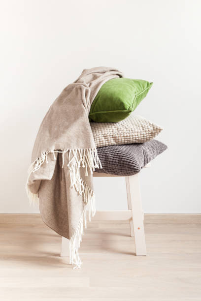 istock gray and green cushions, throw. cozy home 924787476