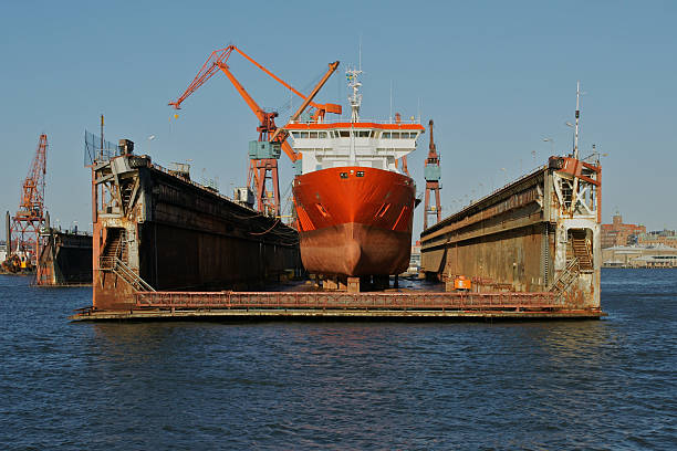Boat receiving maintenance on dry dock Ship repair at dry dock in Gothenburg harbour, Sweden dry dock stock pictures, royalty-free photos & images