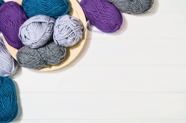 istock Knitting accessories top view on white wooden background 924792386