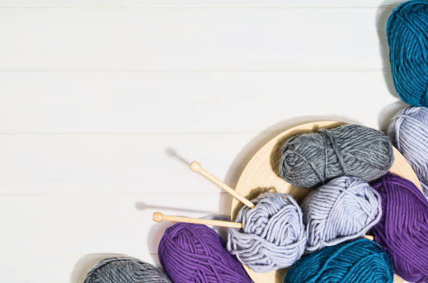 istock Knitting accessories top view on white wooden background 924792406