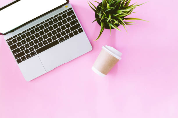 istock Top view of laptop computer and cup coffee on pink background.Flat lay 924793292