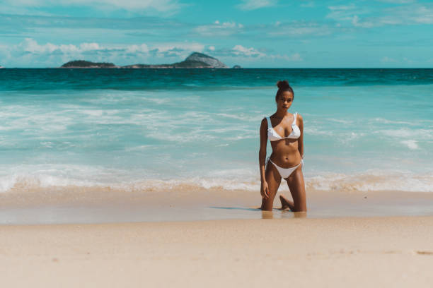 istock Black female on the beach with ocean behind 924796554