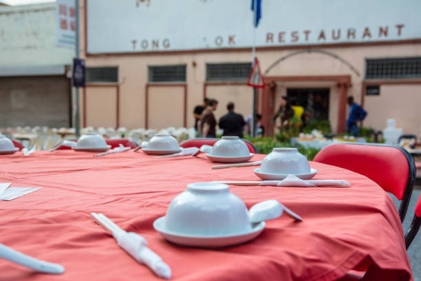 Table arrangement before dinner at a luxury restaurant. Waiters' service preparations. White tablecloths. Design of plates, forks and knives. Celebration dinner, lunch. Restaurant with Bosphorus view. Elegant dining table. Dinner chair.