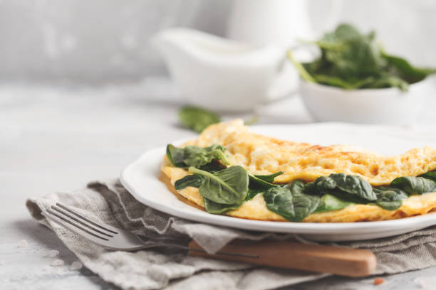 istock Omelette stuffed with spinach and cheese for a breakfast. Breakfast concept. 924797630