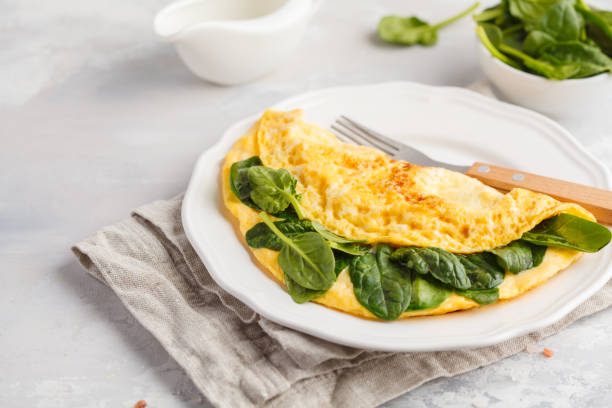 istock Omelette stuffed with spinach and cheese for a breakfast. Breakfast concept. 924797648