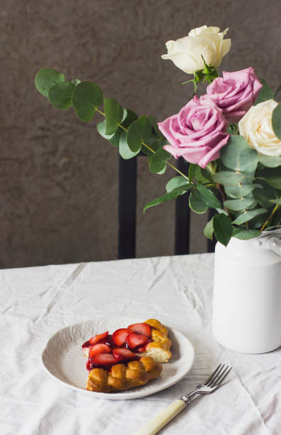 istock Dining table with flowers and strawberry pie, rustic style 924798636