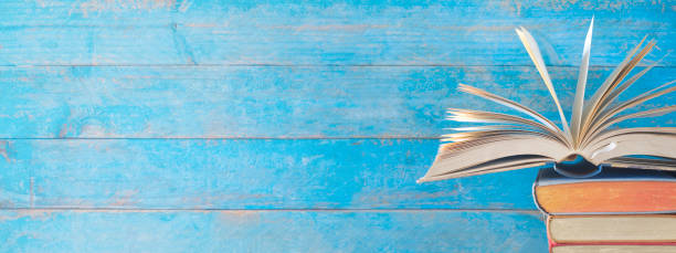 istock Opened Book on a stack of old books, panorma, good copy space 924801804