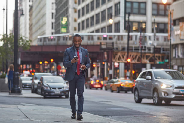 istock Smiling businessman using smart phone on street 924802008
