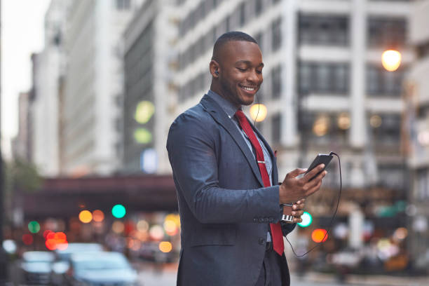 istock Smiling businessman using smart phone in city 924802012