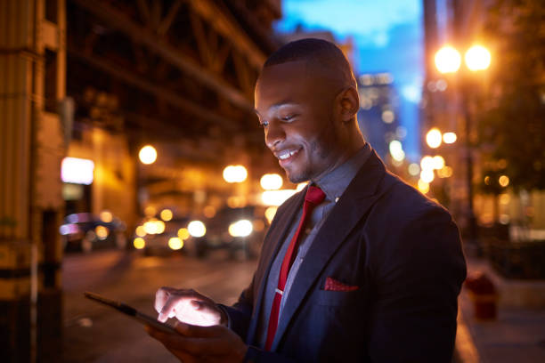istock Businessman using digital tablet in city at night 924802192