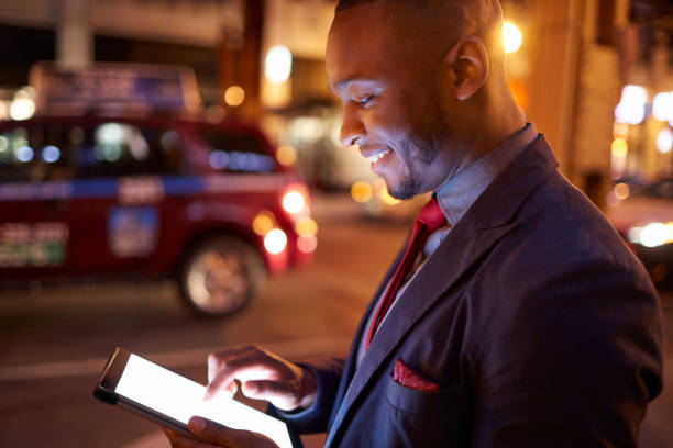 istock Businessman touching screen of tablet PC at night 924803274