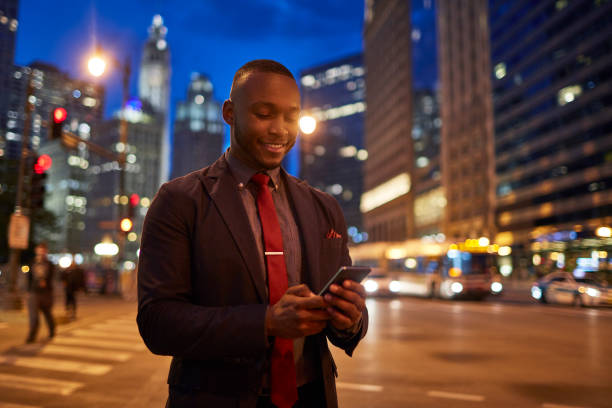istock Businessman using mobile phone on street in city 924804568