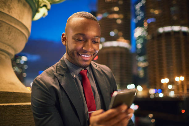 istock Businessman using mobile phone against buildings 924804880