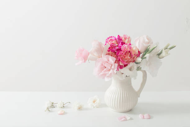 istock pink and white flowers in vase on white background 924805340