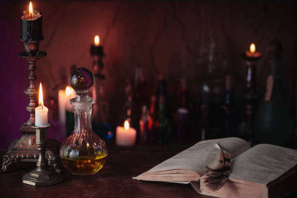 istock Magic potion, ancient books and candles on dark background 924805376
