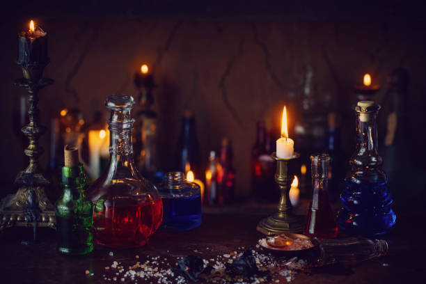 istock Magic potion, ancient books and candles on dark background 924805388